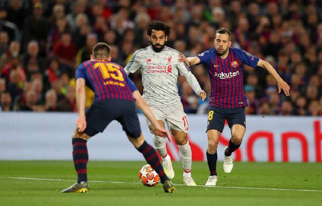 Penyerang Liverpool, Mohamed Salah (tengah) dibayangi dua pemain Barcelona pada pertandingan leg pertama semifinal Liga Champions, di Camp Nou. (Twitter/LFC)