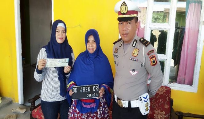 					Kanit Regident Samsat Polres Jeneponto, IPDA Aldiansyah mengantar plat dan dokumen ke rumah warga. (BERITA.NEWS/Muh Ilham). 