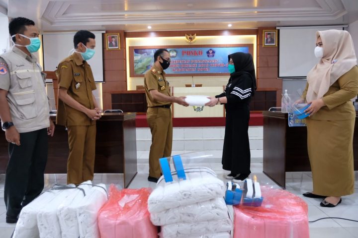 Perwakilan keluarga Yasin Limpo, Tenri Olle YL menyerahkan APD baju Hazmat yang diterima langsung Skeda Gowa, Muhlis di Posko Indk penanganan Covid 19 Kabupaten Gowa.(foto:berita.news/Putri)