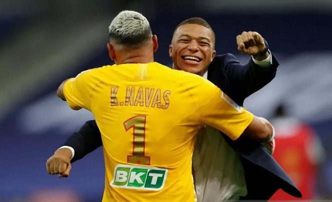 					Kiper Paris Saint-Germain Keylor Navas (tampak punggung) melakukan selebrasi bersama Kylian Mbappe selepas menjuarai Piala Liga Prancis dengan mengalahkan Olympique Lyon lewat adu penalti dalam partai final di Stadion Stade de France, Saint-Dennis, Prancis, Jumat (31/7/2020) waktu setempat. (ANTARA/REUTERS/Christian Hartmann)