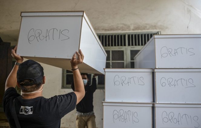 					Pekerja mengangkut peti jenazah untuk didistribusikan di TPU Petamburan, Jakarta Pusat, Selasa (6/7/2021). Dinas Pertamanan dan Hutan Kota DKI Jakarta mendistribusikan peti jenazah gratis bagi warganya yang meninggal dunia akibat COVID-19. ANTARA FOTO/M Risyal Hidayat/foc.