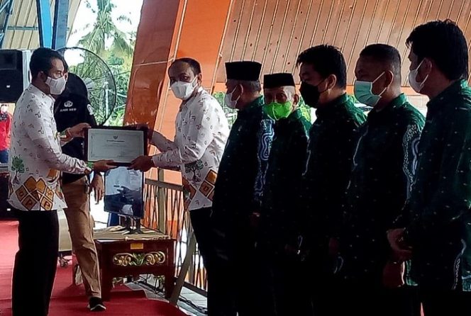 					Kapolres Sinjai AKBP Iwan Irmawan menerima penghargaan sebagai pembina koperasi terbaik di Kabupaten Sinjai dari Bupati Sinjai Andi Seto Gadhista Asapa di tribun lapangan Sinjai Bersatu, Sabtu (11/12/2021).