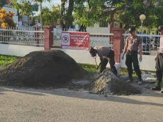Personel Polres Sinjai Lakukan Pengecoran Jalan Berlubang di Jalan Syarif Al Qadri. [Foto: Istimewa]